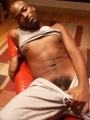 Hot black slowly strip teases so he could play with his hot gay body and his huge dick